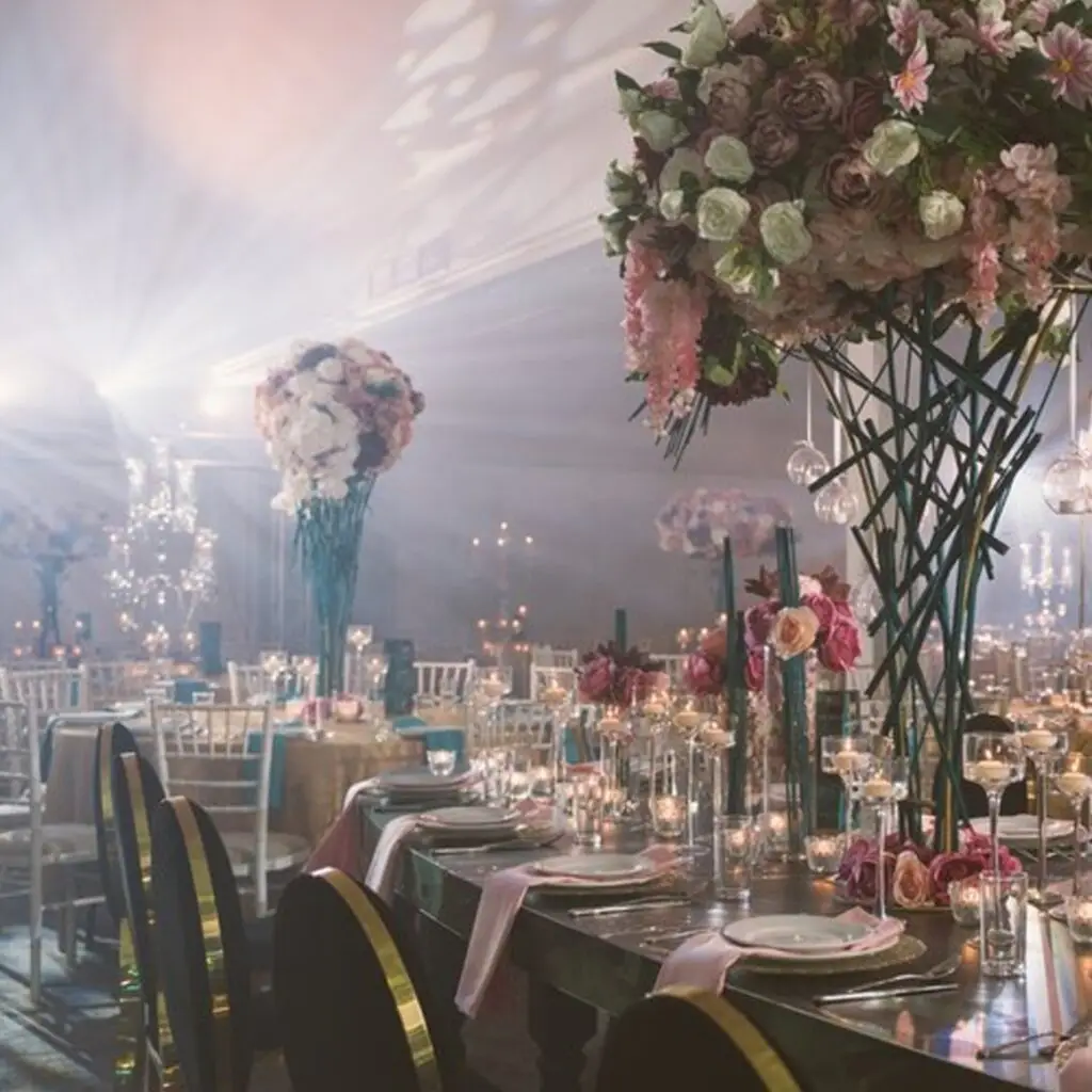 Elegant wedding reception setup with floral arrangements, candles, and decorated tables ready for guests.